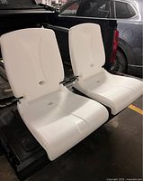 Front view of two white Step2 Flip Seats on truck tailgate