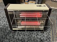 Creative QH 1500 Quartz Fan Heater in beige and brown casing with dual quartz heating elements visible and metal protective grille