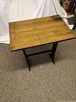 Top down view of antique tiger oak table showing rectangular top with pronounced tiger oak cross-cut grain pattern.