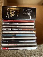 Photo of jazz CD spines showing titles and artists for various jazz albums including The Verve Story box set, Tony Bennett, Miles Davis, Dexter Gordon, Thelonious Monk, Duke Ellington, and more.
