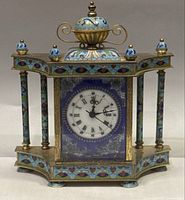 Front view of entire clock showing dial and enamel decoration