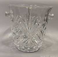 Front view of clear Slovakian heavy lead crystal ice bucket with detailed cut patterns and visible handle on right side.