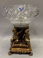 Full view of vintage cut crystal fruit bowl showing Bohemia label, cut patterns, marble top, and brass cherub base