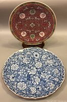 Front image showing Japanese blue floral platter in front and Chinese red decorated plate in back