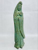 Front angled view of the 11-inch tall Bodhisattva Kannon statue holding a baby, showing green patina and detailed drapery.