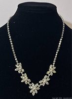 Front view of vintage Sherman rhinestone necklace choker displayed on black jewelry bust.
