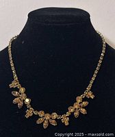 Front view of Sherman rhinestone choker displayed on black velvet bust, showing floral and cluster rhinestone design.