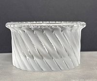 Side angled view showing twisted ribbed design on the bowl sides and clear to frosted crystal texture. Marked as copyrighted by maxsold.