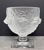 Front view of frosted glass footed bowl with relief fruit and leaf motif on square base