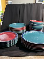 Stacks of dinner plates, salad plates, cereal and soup bowls showing colors and patterns.