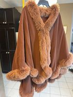 Front view of brown wool cape with genuine fur trim on collar, cuffs, and hem.