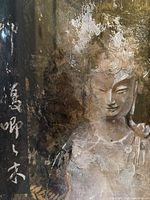 Close-up showing the serene figure with textured, earthy tones and Chinese calligraphy on the left.