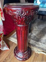 Full view of the carved mahogany-tone fluted pedestal column showing proportion and finish.