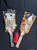 Pair of vintage Japanese hagoita paddles with 3D fabric figures of Kabuki actor and Geisha, alongside a Coke can for scale.