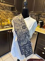 Scarf draped over mannequin, showing length and pattern detail