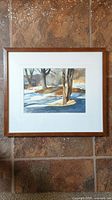 Framed watercolour painting by Bruce Lepper depicting a snow-covered backyard with trees and shadows.