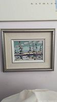 Oil on board landscape painting framed in silver with double mat. Signed lower right.