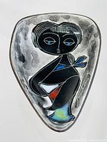 Full view of the triangular ceramic miniature bowl showing colorful abstract woman design with signature.