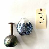 Both bud vases side by side showing size and color differences, with a lot tag