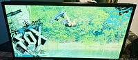 Light box displaying slide with wakeboarder in mid-air performing a trick, Fox branding on corners.