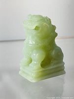 Photo of the carved jade dog lion statue front side showing detailed features and facial expression.