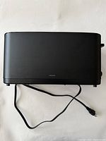 Black Zwilling toaster viewed from top showing rectangular shape, cool-to-touch matte black exterior, and power cord.