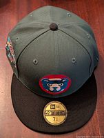 Front view of the fitted baseball cap with Chicago Cubs bear logo and size sticker on brim.