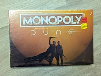 Front of Dune Monopoly game box sealed in plastic wrap, showing main artwork and title.