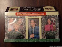 Front of the Everybody Loves Raymond DVD collector's box with character images, series title, and episode count on discs sticker
