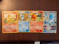 Photo showing all four jumbo Pokemon cards: Charmander, Squirtle, Torchic, Glaceon V-Star.