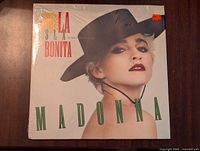 Front cover of Madonna La Isla Bonita vinyl showing Madonna in black hat and green text, shrink-wrapped and sealed.