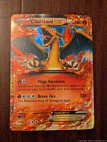 Front of Charizard EX card showing illustration, HP 180, and attack details Mega Ascension and Brave Fire