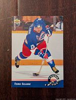 Front of Teemu Selanne rookie hockey card showing player in Winnipeg Jets uniform skating with puck.