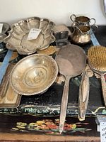 Group shot of all sterling silver pieces on painted chest