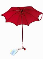 Handmade red parasol opened showing scalloped edges and metal ribs supporting canopy, with original tags attached to handle.
