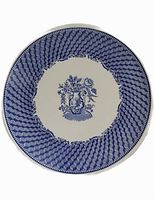 Top view showing blue geometric pattern and central floral bouquet on cake plate.