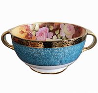 Front side view of the vintage Nippon fruit bowl showing turquoise crackle exterior, gold accented handles, and floral interior with pink roses.