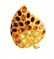 Front view of the leaf-shaped brooch showing gold-tone metal and amber to clear faceted crystals arranged as leaf veins.