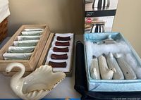 Photo showing six wooden chopstick rests arranged in a wooden tray and porcelain swan-shaped bowl with gold rim, and porcelain bird-shaped sugar bowls in a cushioned box.