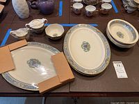 Overview of all serving platters, bowls, sugar and creamer displayed on table