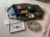 Full lot arrangement showing six trinket boxes and dishes placed on decorative tray and carpet, plus the Swarovski keychain box nearby.