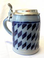 Front view of the German beer stein showing the blue diamond pattern and metal lid.
