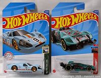 Lot with two Hot Wheels cars sealed in original blister pack packaging, front view showing branding, card details, and car models inside.
