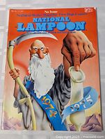 Front cover of the National Lampoon magazine, January 1975 issue, showing the illustrated elderly man with a beard and a large hand holding a scroll with years 1974 and 1975.