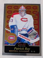 Foil style insert hockey card featuring Patrick Roy in Montreal Canadiens goalie uniform with repeating Canadiens logo background and gold logo patch.