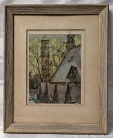Framed art print featuring a winter scene with church towers and snow-covered rooftops.