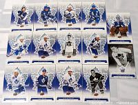 Photo showing 12 Toronto Maple Leafs Centennial Edition hockey cards including players such as Charlie Conacher, Hap Day, Frank Mahovlich, Johnny Bower, Darryl Sittler, Rick Vaive, and Allyn McCauley