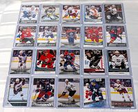 Photo showing a full layout of 20 Upper Deck Young Guns hockey rookie cards arranged on a flat surface in a 4x5 grid, featuring various NHL players from different teams.