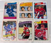 Photo of six vintage hockey cards featuring Michel Goulet, Bryan Saillants, Chris Chelios, Ron Duguay, Peter Mahovlich, and Don Lever.