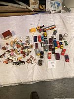 Wide shot of the lot featuring farm animals on the left and toy vehicles on the right